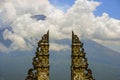 View of Bali volcano Mount Agung through the beautiful and majestic gate of the hindu Pura Lempuyan temple of Indonesia in Asia ho