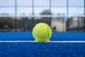view of a ball on the baseline of a blue paddle tennis court Royalty Free Stock Photo
