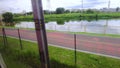 View of the banks of the River Pinheiro through the window of a train