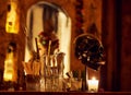 View of a bar counter decoration with a metal skull, glass jar, spoons, and other equipment