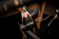 View on barbell in gym. Strong athlete woman preparing equipment for bodybuilding training.