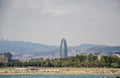 View of Barcelona, Barceloneta beach, modern glass windows tower Agbar and the Mediterranean sea