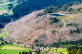 View of a bare hill with fallen trees  in South Tyrol, Italy after a windstorm, with a pool on top Royalty Free Stock Photo