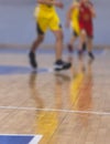 View of basketball court hall indoor venue with junior teenage school team playing in the background, basketball match game on Royalty Free Stock Photo