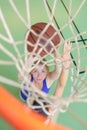 View through basketball hoop sportswoman Royalty Free Stock Photo