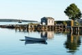 View of Bass Harbor with row boat, dock, labster traps, and fish Royalty Free Stock Photo