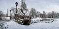View of Bastion Hill park and The Freedom Monument in Riga, Latvia. Winter landscape in snowy park with beautiful small bridge Royalty Free Stock Photo