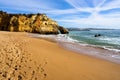 View of Batata beach and the sea under a blue sky in Algarve, Portugal