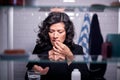 View Through Bathroom Cabinet Of Mature Woman Taking Medication With Glass Of Water Royalty Free Stock Photo