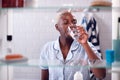 View Through Bathroom Cabinet Of Woman Drinking Glass Of Water Royalty Free Stock Photo