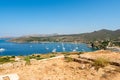 View of the bay and anchorage full of sailboats from Temple of Poseidon at Cape Sounion on sunny day, Sounion, Greece Royalty Free Stock Photo