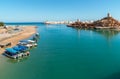 View of bay of Sur with Al Ayjah Lighthouse, forts on the rocks and traditional fish boats on the beach, Sultanate of Oman in the Royalty Free Stock Photo