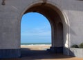 View of the beach through the arcade.