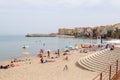 View of the beach of Cefalu with the old city in the background