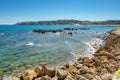 View of the beach Du Ponteil of the town Antibes.with the Cap d `Antibes peninsula in the background Royalty Free Stock Photo