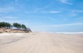 View of the beach with dunes, tall trees and sky with clouds Royalty Free Stock Photo