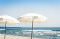 View of the beach of ionic sea near Catania, Sicily, Italy, Lido Cled with white umbrellas