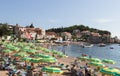 View of the beach with many sun beds and tourists in Przhno on a quiet, calm, hot day