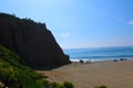 View of the beach with mountains and blue skies and blue ocean water