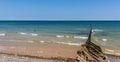 A view from the beach path out to sea toward the wind turbines on the horizon at Sheringham, Norfolk, UK Royalty Free Stock Photo