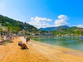 View of the beach of Port de Soller with people lying on sand, Soller, Balearic islands, Spain. Royalty Free Stock Photo