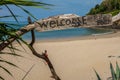 A view of a  beach with a rustic welcome sign on the island of Koh Lanta, Thailand, the beach is totally empty and idyllic with Royalty Free Stock Photo