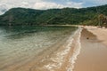 View of beach, sea and forest on cloudy day in Paraty Mirim.