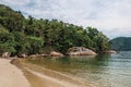 View of beach, sea and forest on cloudy day in Paraty Mirim.