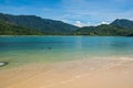 View of beach, sea and forest on sunny day in Ilha do Pelado.