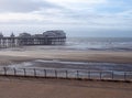 View of the beach and south pier at blackpool with the sea in front of the promenade and seagulls flying in a blue sunlit sky Royalty Free Stock Photo