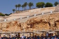 View of the beach and stairs to the CLUD FANARA hotel. The name of the hotel is carved in stone.