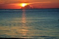 View from the beach of sunrise with cloud cover