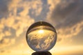 view of the beach in sunset inside crystal balls on a timber.