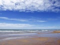 Beach and water surface of sea or ocean with horizon and blue sk Royalty Free Stock Photo