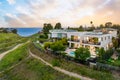 View of beachfront property, illuminated by the setting sun