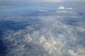 View of beautiful abstract soft white cloudscape with shades of blue sky background from flying plane window Royalty Free Stock Photo