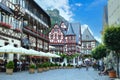 view beautiful ancient European Bacharach city, tourists walk along historical streets, sitting in cafes, old half-timbered houses