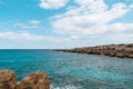 A view of a beautiful blue lagoon between rocks with a blue sky in the background. View of the sea with turquoise blue water on a Royalty Free Stock Photo