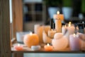 View at beautiful burning candles on wooden table through glasses