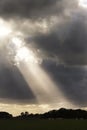 View on a beautiful cloudscape, where a bundle of light falls through a hole between the clouds Royalty Free Stock Photo