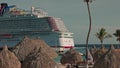 View of beautiful cruise ship with tourists rideing roller coaster in Curacao port.