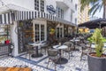 View of beautiful exterior of urban restaurant with prepared tables for visitors on sunny summer day.