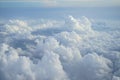 View of beautiful free form heaven cloud with shades of blue sky background from flying plane window