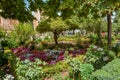 View of the beautiful garden in Alhambra complex and a queue of people waiting for entering the Nasrid Palaces