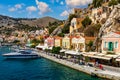 View of the beautiful greek island of Symi Simi with colourful houses and small boats. Greece, Symi island, view of the town of Royalty Free Stock Photo