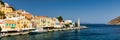 View of the beautiful greek island of Symi (Simi) with colourful houses and small boats. Royalty Free Stock Photo