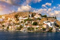 View of the beautiful greek island of Symi (Simi) with colourful houses and small boats. Royalty Free Stock Photo