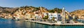 View of the beautiful greek island of Symi (Simi) with colourful houses and small boats. Greece, Symi island Royalty Free Stock Photo