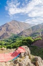 View on beautiful High Atlas Mountains landscape with lush green valley, rocky peaks and red carpet, Morocco, Africa Royalty Free Stock Photo