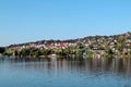 View of the beautiful houses on the shore of the fjord in the vicinity of Bergen on a clear sunny day, Norway.